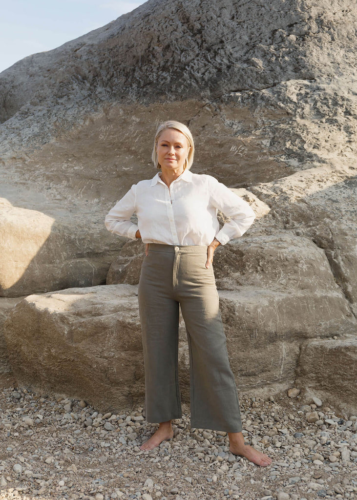 woman wearing a linen white button up shirt.